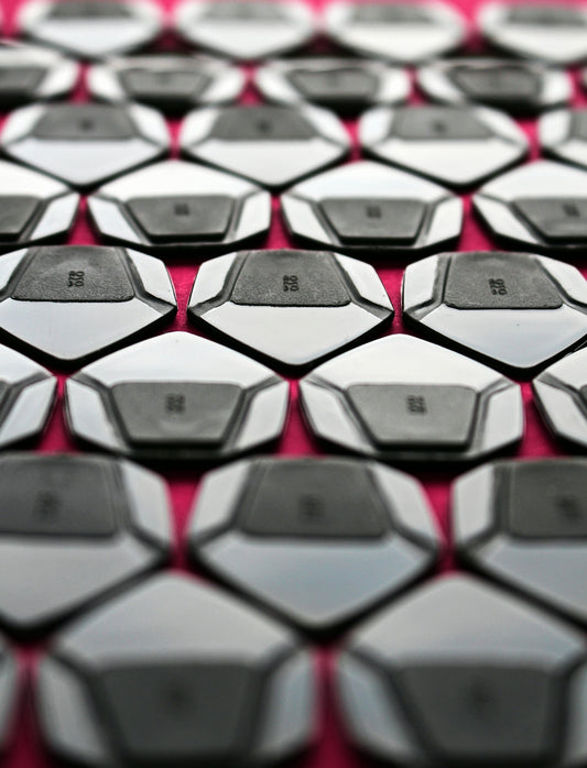 a close up of a computer keyboard on a red surface